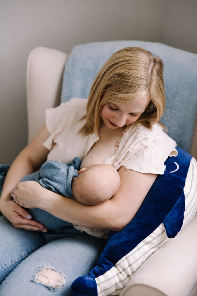 An intimate in-home breastfeeding photography session in San Antonio. Featuring a mother and baby sharing a quiet moment of connection. Captured in natural light, this lifestyle photo highlights the emotional bond and beauty of motherhood. Perfect example of documentary-style breastfeeding photography for families seeking authentic memories at home.
