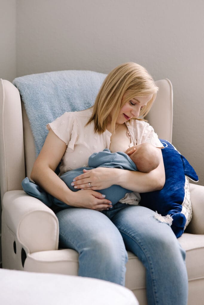In-home breastfeeding photography session in San Antonio. A natural, candid moment between mother and baby. This lifestyle portrait captures the love, nourishment, and quiet strength of motherhood in a relaxed home environment.
