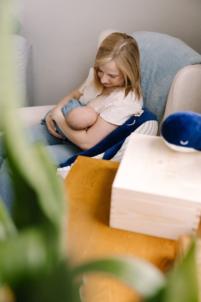 An intimate in-home breastfeeding photography session in San Antonio. Featuring a mother and baby sharing a quiet moment of connection. Captured in natural light, this lifestyle photo highlights the emotional bond and beauty of motherhood. Perfect example of documentary-style breastfeeding photography for families seeking authentic memories at home.
