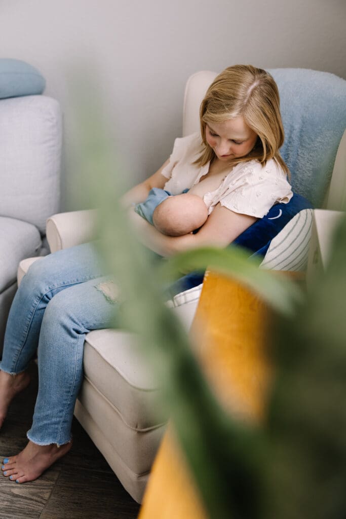 An intimate in-home breastfeeding photography session in San Antonio. Featuring a mother and baby sharing a quiet moment of connection. Captured in natural light, this lifestyle photo highlights the emotional bond and beauty of motherhood. Perfect example of documentary-style breastfeeding photography for families seeking authentic memories at home.
